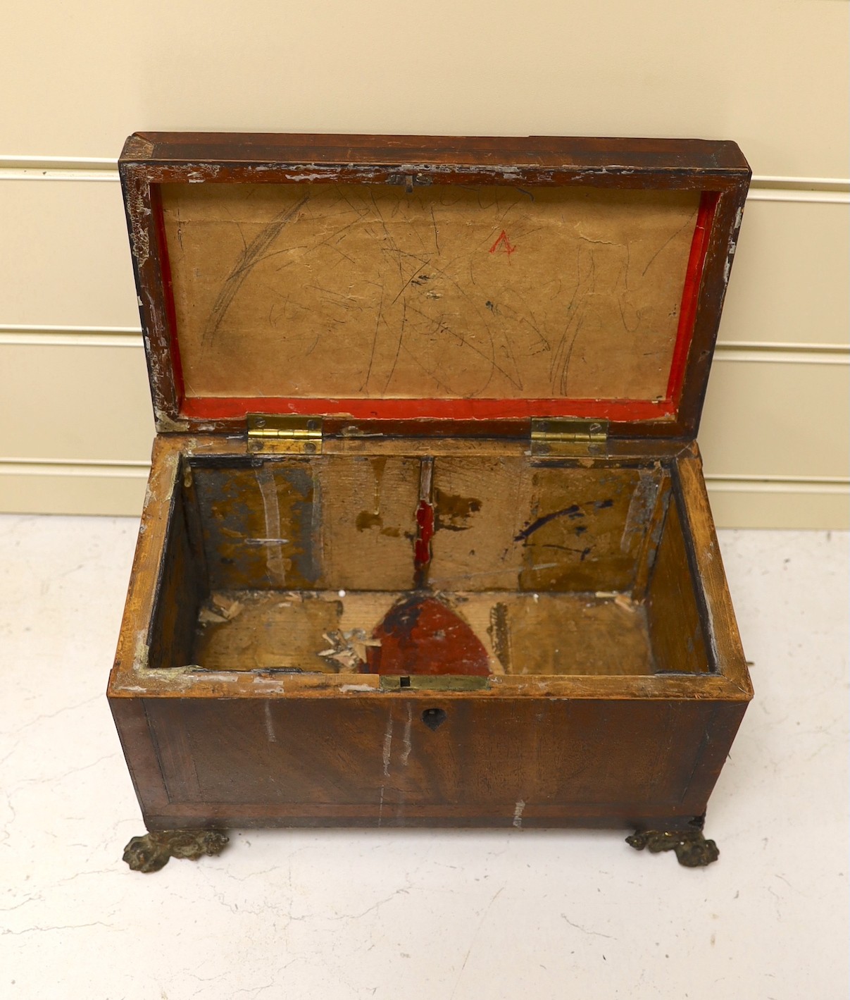 A George IV mahogany tea caddy (a.f.), together with a mounted antler plaque, and a bone handled magnifying glass